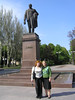 Beth > After spending the morning with my grandfather's first cousin, Maria Borisovna, and her husband Vasily, I went for a walk with the younger generation of the family.  Here I am in the Dnepoproderzinsk town square with my cousin Yulia and the requisite Lenin statue.  Yulia is my third cousin, meaning that my grandfather and her grandmother were first cousins.  She's a few years older than me, but married with two young daughters.  Her husband works in Moscow, and she's hoping to move there soon and open up a bookstore.