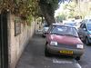 Beth > Ramban Street in front of my house at rush hour.  Yeah, they park on the sidewalk here.  Except sometimes they take up the entire sidewalk, not just part of it.