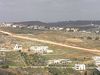 Beth > So if most Israelis accept that the Green Line should - or at the least realistically will end up being - the eventual borders of Israel, why is the Fence being built so far off from the Green Line?  The answer is those red-roofed buildings in the background.